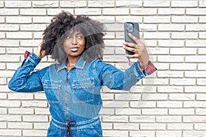 Charming Young Woman in Denim Taking Selfie