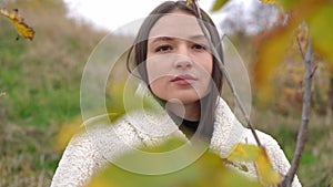 Charming young woman dreaming looking away standing on autumn day outdoors. Portrait of confident beautiful Caucasian