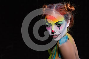 Charming young woman with a face painting clow