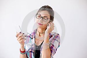 Charming young woman in glasses enjoying music