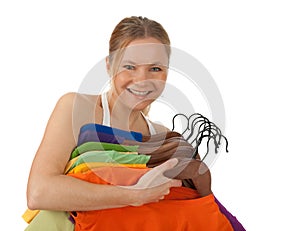Charming young woman holding colourful clothes photo