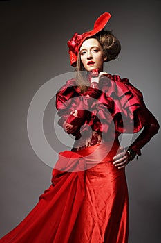 Charming young woman in a red carnival costume and hat.