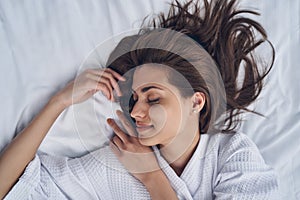 Charming young woman sleeping in bedroom at home