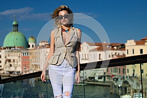 Charming young woman walking in Venice, Italy. Italian summer vacation. Fashion woman on the Venice street. Traveler