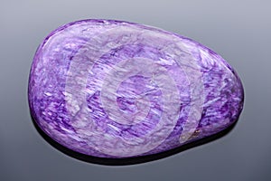 Charoite tumblestone - Very sharp and detailed photo of this rare and beautiful stone