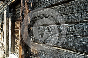 Charred black wooden wall. Angle Image of a burned boards of slum house