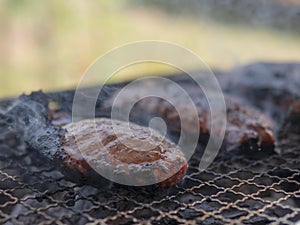 Charred pork meat on the grill