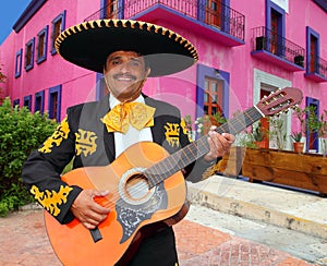 Charro Mariachi playing guitar Mexico houses photo