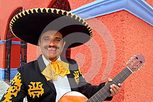 Charro Mariachi playing guitar Mexico houses photo