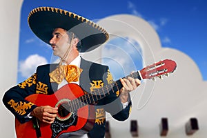 Charro Mariachi playing guitar Mexico houses photo