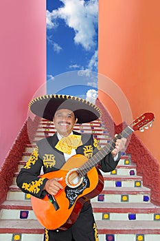 Charro Mariachi playing guitar in Mexico stairway