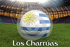 Charrua on Uruguay language on football team ball on big stadium background. Uruguay Team competition concept. Uruguay flag on bal photo