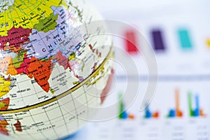 Chart graph paper with globe world Asia map on . Finance, Account, Statistics, Investment, Analytic research data economy.