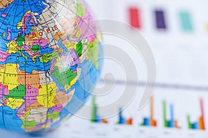 Chart graph paper with globe world Europe map on . Finance, Account, Statistics, Investment, Analytic research data economy.