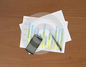 Chart, Pen and Smart Phone on the Worktable