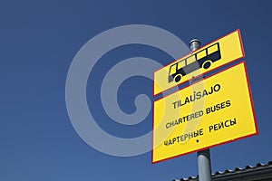 Charter bus traffic sign with Finnish, English and Russian text