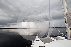 Charter Catamaran on Calm Water Before Rain Storm photo