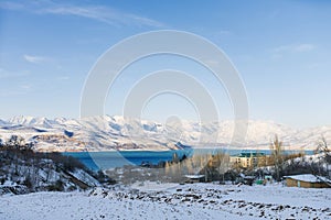 Charvak mountain lake in Uzbekistan on a snowy frosty day, surrounded by the Tien Shan mountains