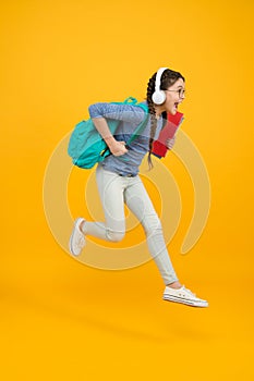 Chase your dream. Energetic kid hurry to school. Happy child in energetic jump yellow background. Energetic mood