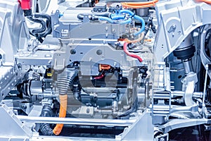 Chassis of the electric car with powertrain and power connections closeup. Blue toned. photo