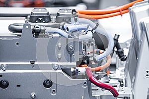 Chassis of the electric car with powertrain and power connections closeup. Blue toned.