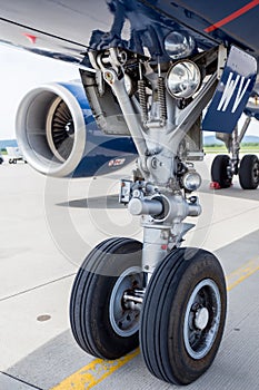 Chassis and turbine engine of modern passenger airplane Airbus A319 on runway. Service and