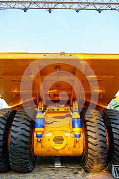 Chassis with wheels for commercial cargo transportation. Traffic safety. A large black rough tire for trucks. Working in a quarry