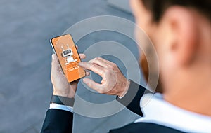 Businessman holding smartphone, using chatbot in business operations