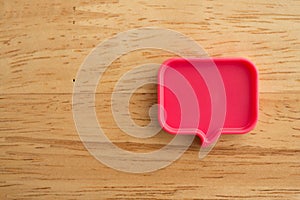 Chat bubbles on social media communication. Red chat bubbles icon messages on wooden background