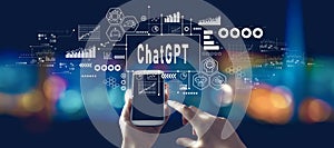 Chatbot ChatGPT - Aartificial Iintelligence theme with person using a smartphone at night