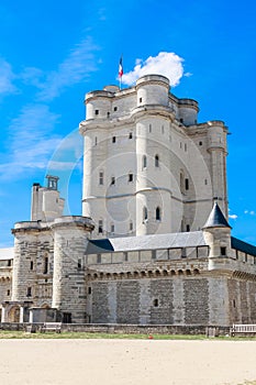 Chateau de Vincennes in Paris. France castle with French national flag under the sunny blue sky