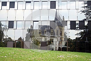 Chateau reflected in office building