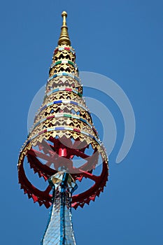 Chatra, or multi-tiered umbrella, an auspicious symbol in Buddhism. Roof of a buddhist temple in Bangkok, Thailand