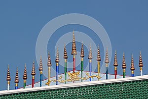 Chatras, or multi-tiered umbrellas, an auspicious symbols in Buddhism. Roof of a buddhist temple in Bangkok, Thailand