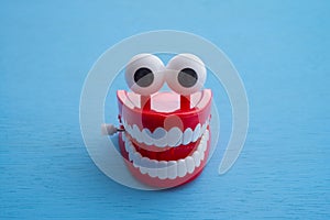 Chattering teeth toy wind up moving on blue background. Funny, comedy, relax time