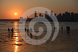 Chawpatty beach in Mumbai during sunset with silhouettes