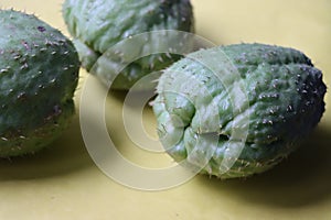 Chayote fruits or Sechium edule on yellow background