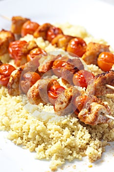chcicken meat and tomato skewers with couscous