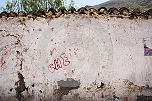 Che Guevara\'s ,che-grafity spray painted black on an abandoned wall in a town in per photo
