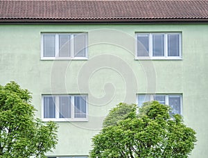Cheap flats windows in  etage house in small town. Low cost photo