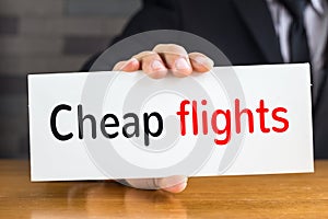 Cheap flights, message on white card and hold by