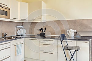 Cheap light small clean kitchen in beige colors