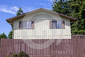 Cheap wooden house with wooden fence in the woods, somewhere in Oregon