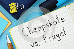 Cheapskate Vs. Frugal sign on the piece of paper
