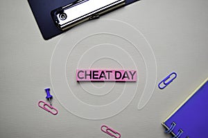 Cheat Day text on sticky notes with office desk concept photo