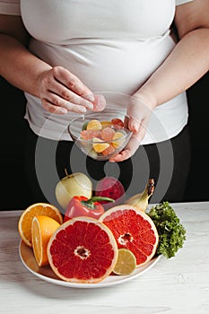 Cheat meal, overweight woman snacking with candies