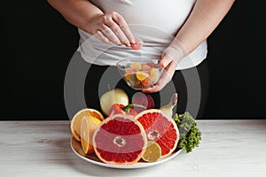 Cheat meal, overweight woman snacking with candies