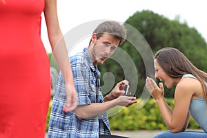 Cheater man cheating during a marriage proposal photo