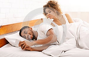 Cheating african man chatting with mistriss in family bed