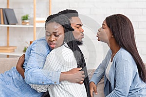 Cheating Afro Man Kissing Another Woman While Hugging With His Wife